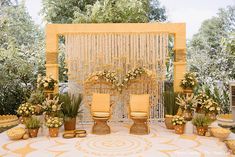 an outdoor ceremony setup with yellow chairs and flowers