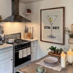 a kitchen with an extra dirty poster on the wall and candles in front of it