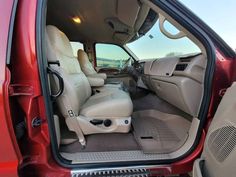 the interior of a red truck with its door open