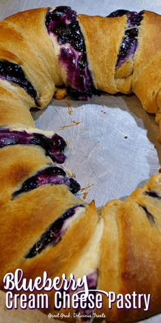 a blueberry cream cheese pastry is shown on a baking sheet with the words blueberry cream cheese pastry above it