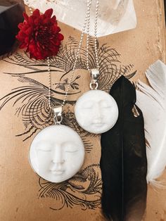 This enchanting Bone Pearl Moon Face necklace, set in sterling silver, captures the magic of the moon in a beautifully carved design. Available in two sizes, the moon face pendant radiates an ethereal charm, making it both a unique statement piece and a symbol of intuition and mystery. The bone pearl adds a natural, organic feel, while the sterling silver setting enhances its timeless elegance. Hanging from an 18" sterling silver ball chain, this necklace blends artistry and elegance, perfect for those who are drawn to the moon's quiet power. Ready to ship, it's a stunning piece for everyday wear or special occasions. Anniversary Gifts Ideas, Face Carving, Face Pendant, White Moon, Face Necklace, Moon Face, Charm Making, Peridot Gemstone, Necklace White