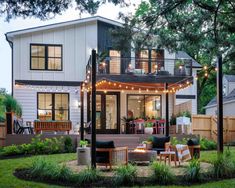 a house with lights on the porch and patio