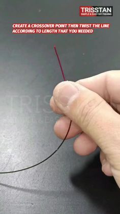 a person is holding a small wire with the end pointing towards it, and there is an arrow in the middle of the line