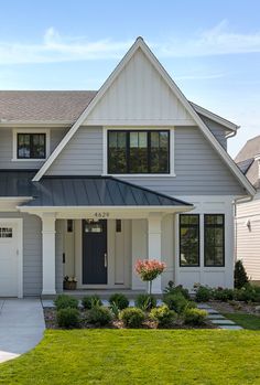 a gray house with white trim and windows