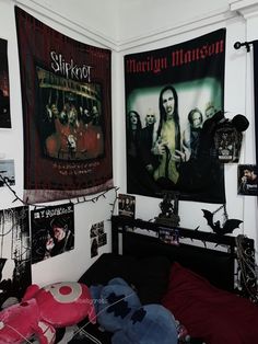 a bedroom with posters on the wall