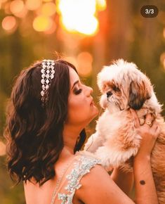 a woman holding a small dog in her arms