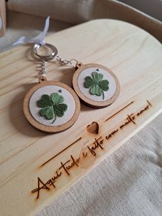 two wooden earrings with green shamrocks on them