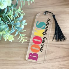 a book bag tag sitting on top of a wooden table next to a potted plant