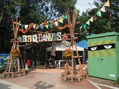 an outdoor area with wooden structures and decorations