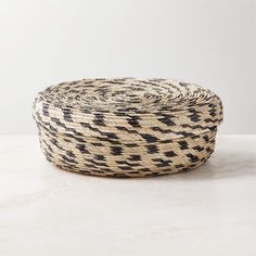 a black and white basket sitting on top of a table