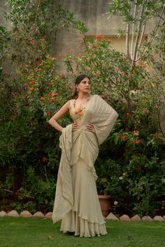 This beautiful saree is perfect for special occasions like weddings or festivals. Made from Chanderi silk georgette, it's lightweight and comfortable to wear. The beige color adds elegance, and the saree comes with a sleeveless blouse that has intricate heavy handwork prints, adding to its charm. Whether you're a mother, sister, wife, or bride, this saree is sure to make you stand out and feel special. Item - Saree Blouse Fabric - Chanderi Silk and Georgette Color - Biege Blouse Sleeve - Sleevel Sleeveless Silk Saree For Wedding, Sleeveless Cutdana Pre-draped Saree For Wedding, Traditional Sleeveless Sharara For Wedding, Sleeveless Anarkali Style Pre-draped Saree In Georgette, Semi-stitched Sleeveless Pre-draped Saree With Zari Work, Elegant Sleeveless Choli With Sheer Dupatta, Fitted Sleeveless Blouse With Sheer Dupatta, Semi-stitched Sleeveless Choli With Dupatta, Sleeveless Wedding Lehenga With Pallu