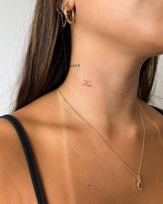 a woman with a small tattoo on her neck