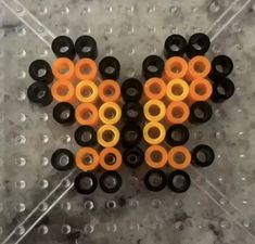 an orange and black object sitting on top of a gray floor next to water droplets