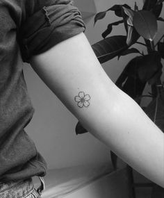 a person with a flower tattoo on their arm