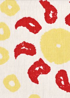 a yellow and red pattern on fabric with circles in the middle, which has been drawn by hand