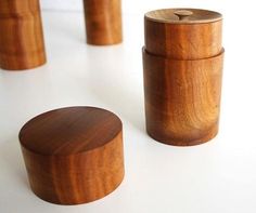 three wooden containers sitting on top of a white table