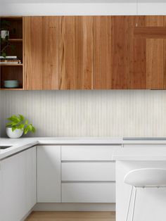 a kitchen with wooden cabinets and white counter tops