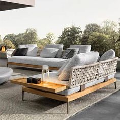 an outdoor living room with couches and tables