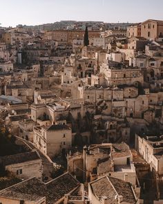 an aerial view of a city with lots of buildings and rooftops in the foreground