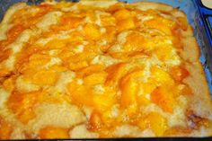 a square casserole with cheese and sauce on it in a glass dish, ready to be eaten