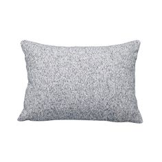 a white and grey pillow with black speckles on the front, against a white background