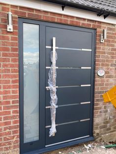 the front door is covered in plastic wrap and taped to it's side with tape