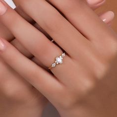 a woman's hand with a gold ring and three diamonds on it, all around her finger