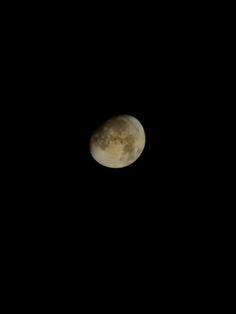 the moon is seen in the dark sky