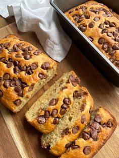 a loaf of chocolate chip banana bread on a cutting board next to a baking pan