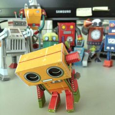 a group of toy robots sitting on top of a table