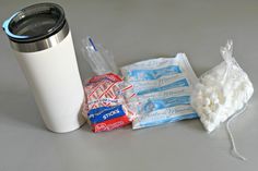 the contents of a travel mug, marshmallows, and coffee cup