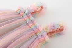 Rainbow Unicorn Tulle Princess Dress: Enchanting Elegance for Your Little One Elevate your baby's style with our enchanting Rainbow Unicorn Tulle Princess Dress. Crafted with a touch of magic and a dash of cuteness, this dress is perfect for the little princess in your life. Let your baby shine in the ethereal beauty of this summer-perfect outfit. Key Features: Material: Polyester, Viscose Style: Cute Season: Summer Age: 9M-5Y Baby Collar: O-Neck Material Composition: Polyester Sleeve Length(cm): Sleeveless A Whimsical Wonderland of Style: Transport your little one to a whimsical wonderland with the Rainbow Unicorn Tulle Princess Dress. The cute and stylish design is perfect for creating magical memories during the warm summer days. Premium Polyester and Viscose Blend: Made with a blend of Pink Unicorn Print Tutu Dress For Summer, Pink Tutu Dress With Unicorn Print For Summer, Playful Pink Tulle Fairy Dress, Multicolor Tulle Fairy Dress For Summer, Playful Tulle Fairy Dress With Ruffles, Cute Tulle Fairy Dress With Ruffles, Cute Rainbow Princess Dress For Summer, Multicolor Ruffled Princess Dress For First Birthday, Cute Unicorn Print Tutu Dress For Dress-up