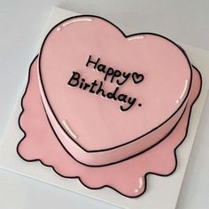 a pink heart shaped cake with the words happy birthday written on it's side