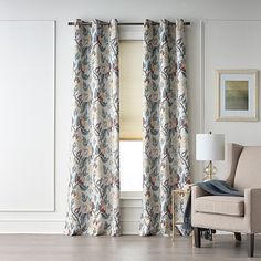 a living room with white walls and curtains