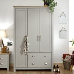 a white armoire sitting next to a wooden floor