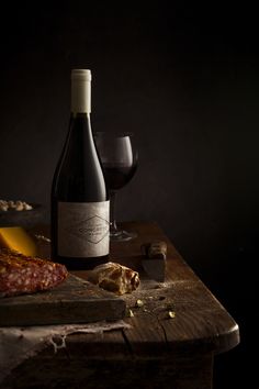 a bottle of wine and some food on a table