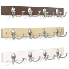 four hooks are mounted on the wall to hold coat and hat hangers in different colors