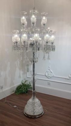 a large crystal chandelier in the corner of a room with wood flooring