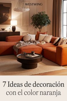 a living room with orange couches and pillows