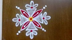 an image of a wooden table with white and red designs on it