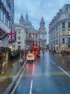 a rainy day in london with traffic on the road