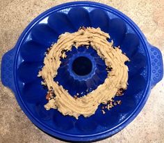 a blue bowl filled with peanut butter on top of a counter