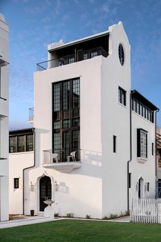 a large white building with a clock on it's side