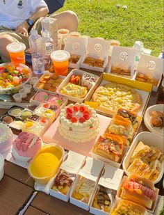 a table topped with lots of different types of cakes and desserts on trays