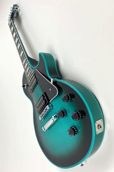 a blue and black electric guitar sitting on top of a table