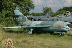 two fighter jets are parked on the grass