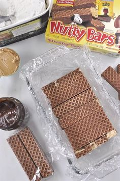 chocolate waffles, peanut butter and nutty bars are sitting on the counter