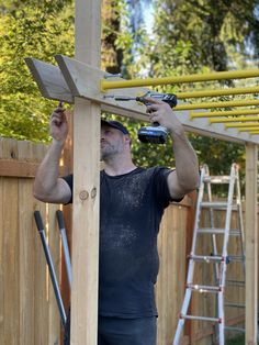 a man is working on a wooden structure