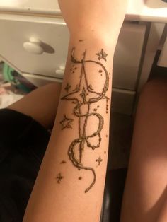 a person with a tattoo on their arm that has stars and the word love written in it