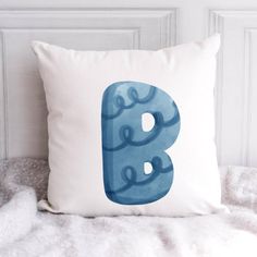 a pillow with the letter b painted on it